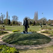 Statue, plinth and landscaped mound